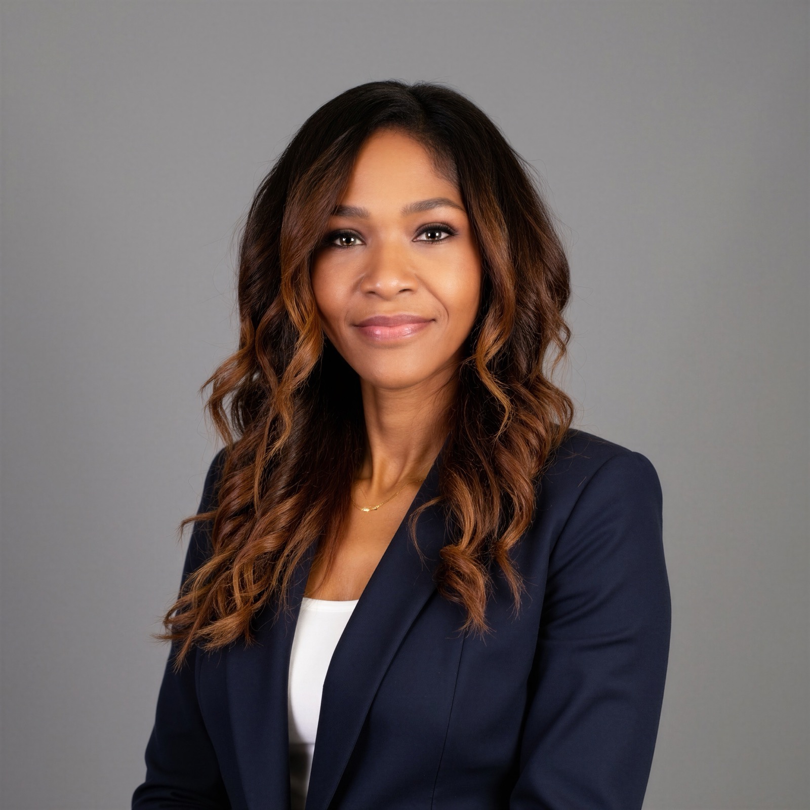 Nicole K. Conley in a navy blazer over white, studio portrait.
